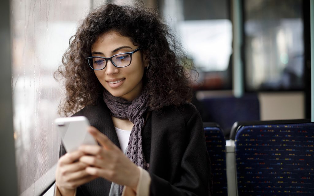 Woman in glasses using her smartphone