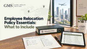 Relocation policy binder with tiered benefits checklist and tablet showing a benefits table