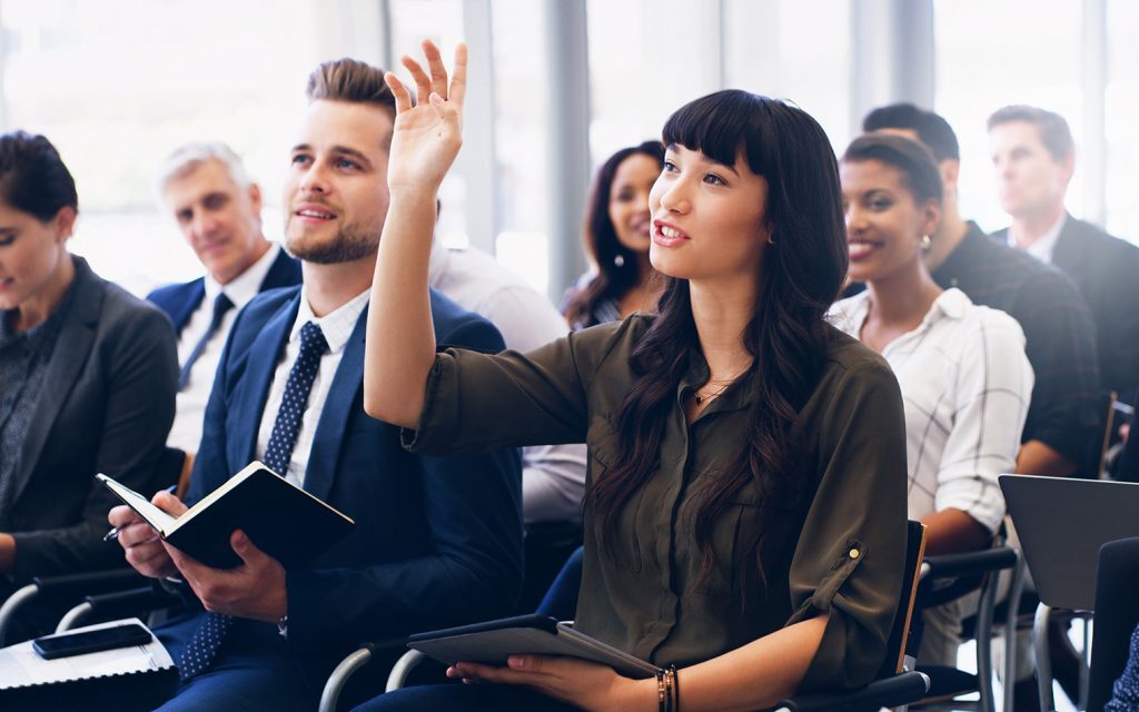 Attendee raising a hand during a corporate training session