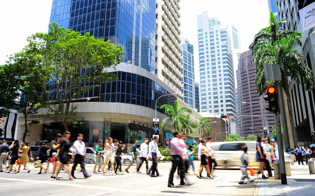 Pedestrians crossing a street in a downtown business district
