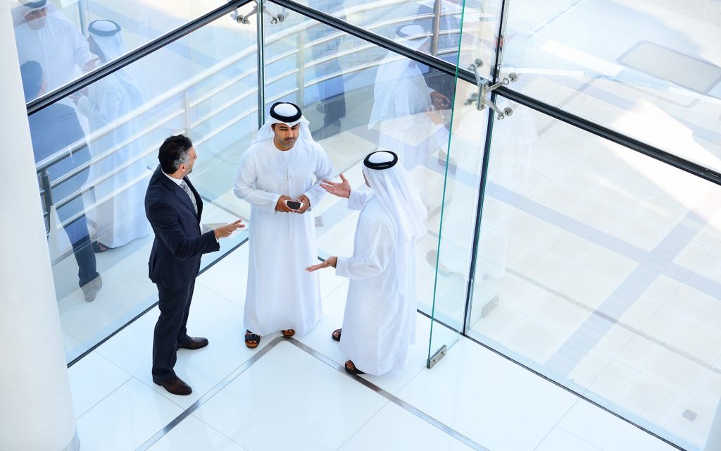 Business colleagues talking in a modern glass office