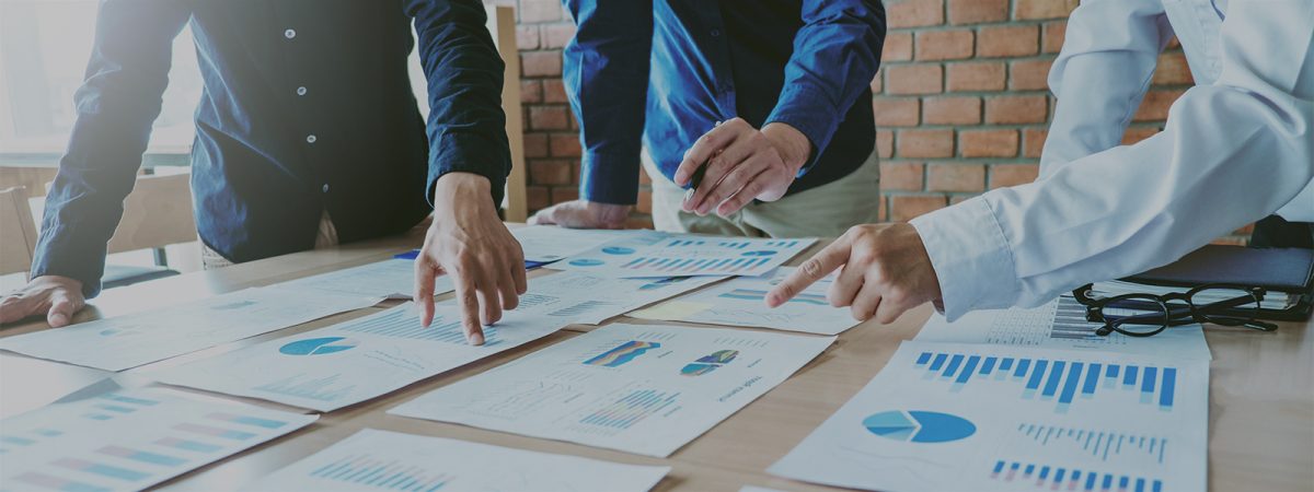 managers reviewing relocation budgets on worksheets