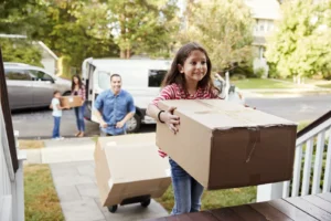 Happy family with young kids moving into a new home