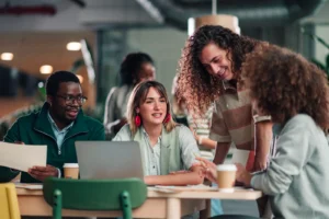 Multiracial team members discussing creative ideas in modern office.